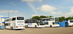 A row of Ridleys Coaches parked in a bus depot